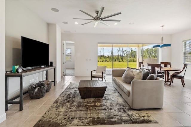 living room featuring light tile patterned flooring, a ceiling fan, recessed lighting, and baseboards