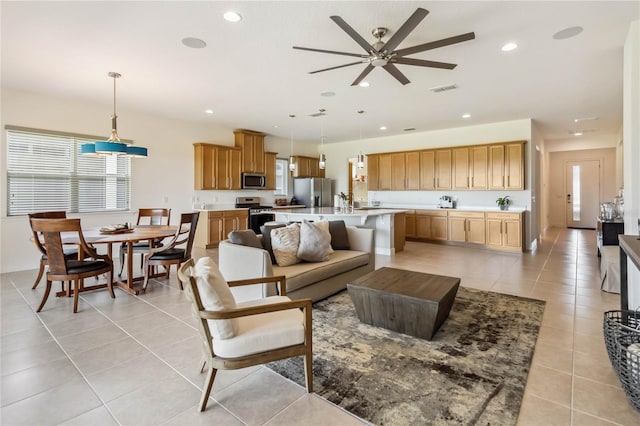 living area featuring visible vents, ceiling fan, recessed lighting, light tile patterned flooring, and plenty of natural light