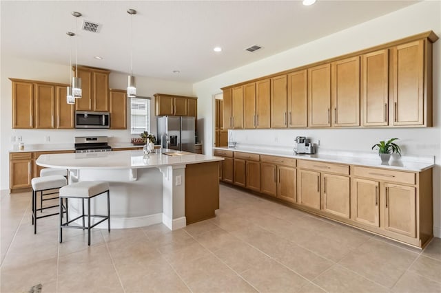 kitchen with stainless steel appliances, visible vents, and brown cabinetry