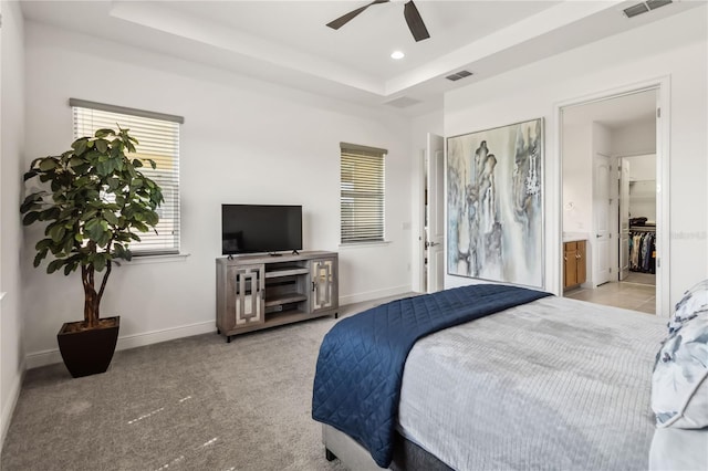 bedroom featuring visible vents, baseboards, a raised ceiling, and carpet