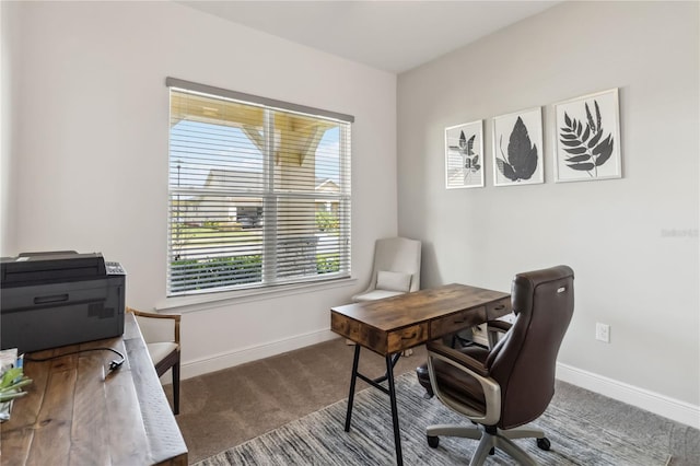 carpeted office space featuring baseboards