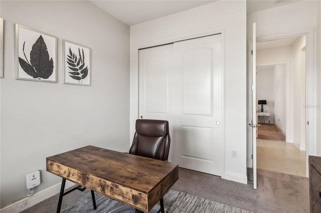 carpeted home office featuring tile patterned flooring