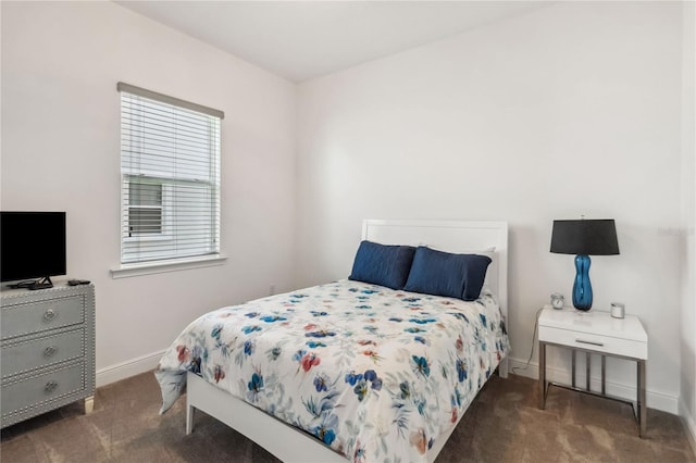 carpeted bedroom featuring baseboards