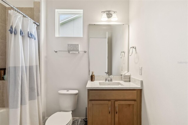 bathroom featuring shower / tub combo, toilet, and vanity