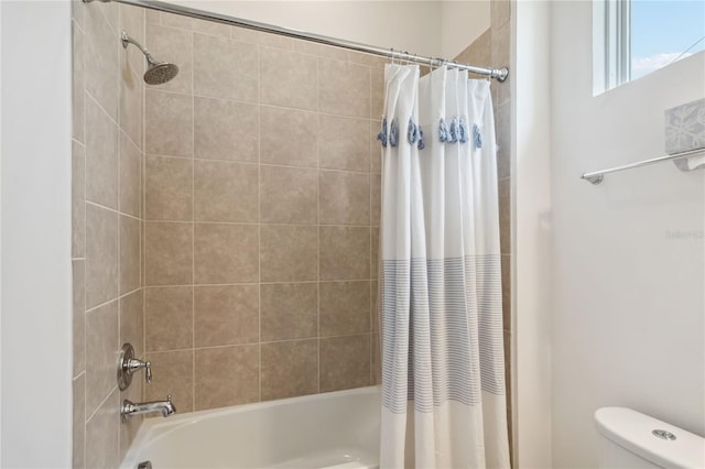 bathroom with toilet and shower / tub combo with curtain