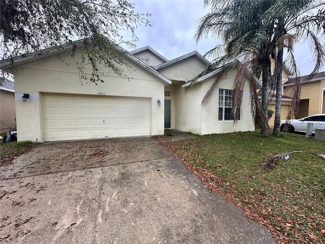 single story home with stucco siding, driveway, and an attached garage