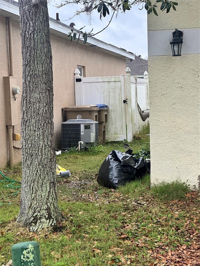 view of yard with cooling unit and fence