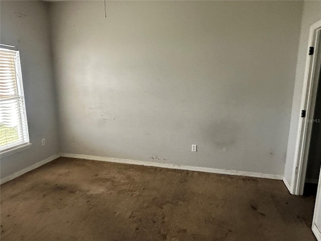 unfurnished room featuring baseboards