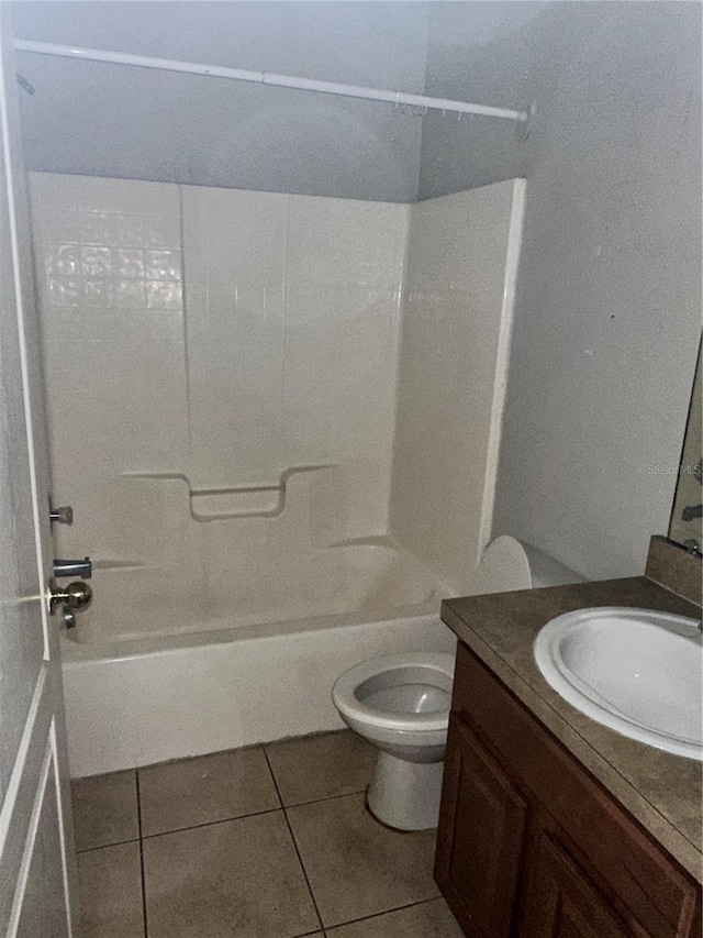 bathroom featuring vanity, tile patterned floors, toilet, and bathing tub / shower combination