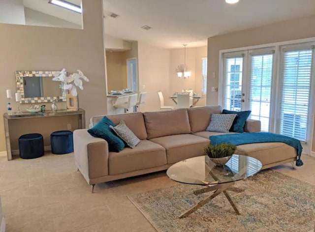 living room with a notable chandelier, baseboards, and visible vents