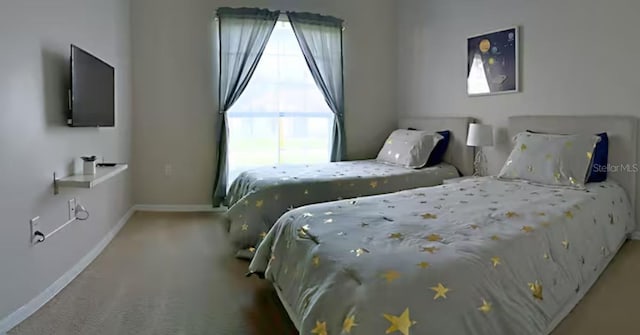 bedroom with carpet and baseboards