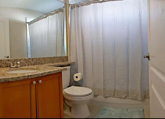 bathroom with toilet, shower / bath combo, and vanity