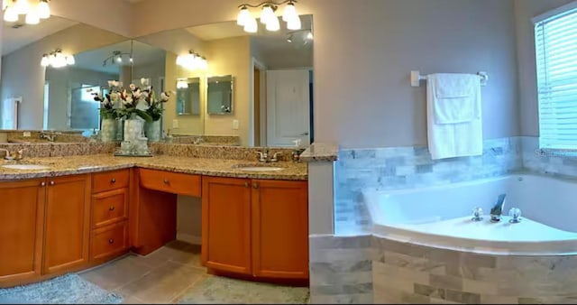 full bathroom featuring double vanity, a garden tub, and a sink