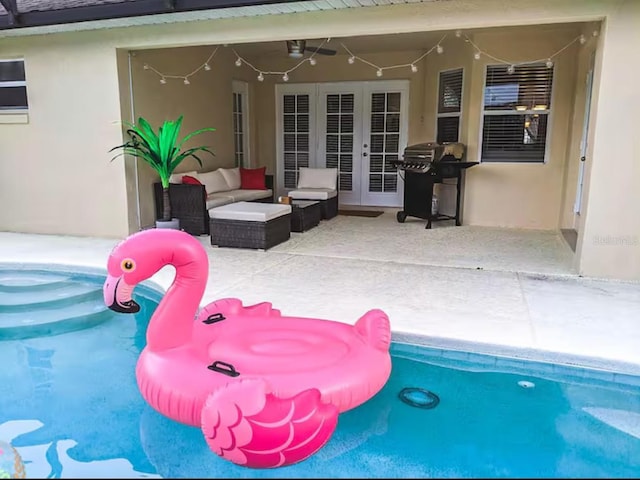 outdoor pool featuring a patio, french doors, an outdoor living space, and ceiling fan