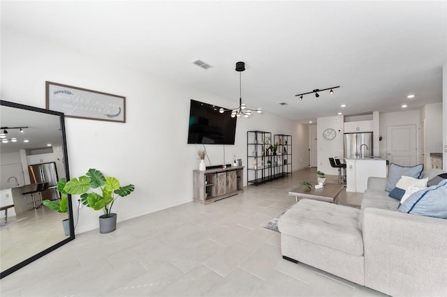 living room with visible vents, a notable chandelier, recessed lighting, rail lighting, and baseboards