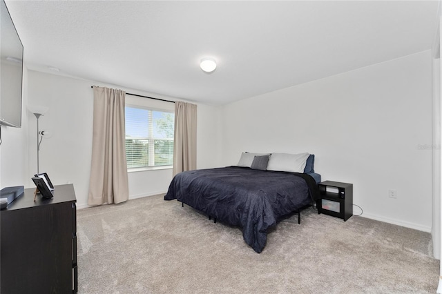 carpeted bedroom featuring baseboards