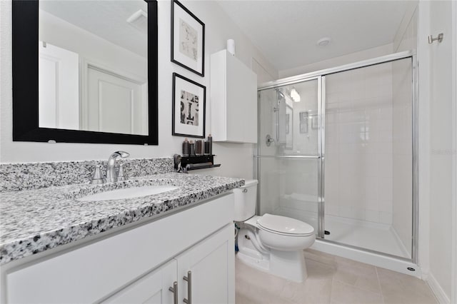 full bath with vanity, tile patterned floors, toilet, and a shower stall