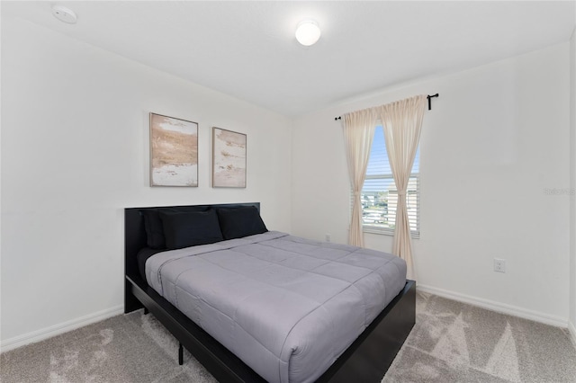 carpeted bedroom with baseboards