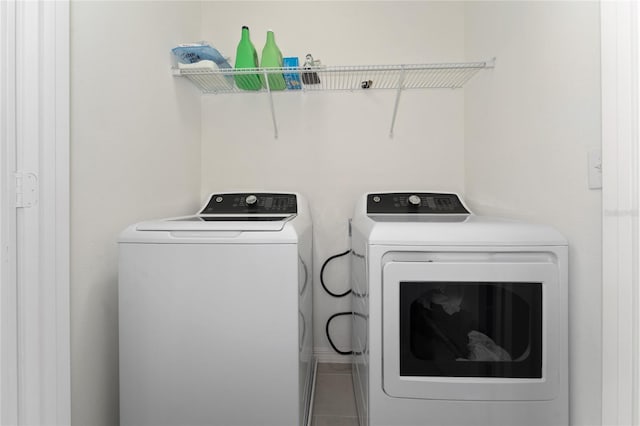 washroom with separate washer and dryer and laundry area