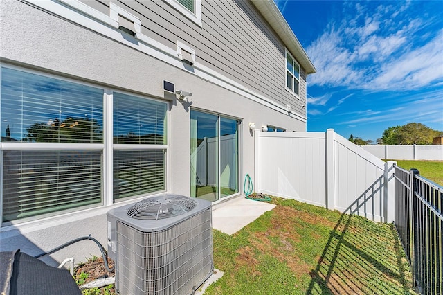 exterior space with a fenced backyard and central AC