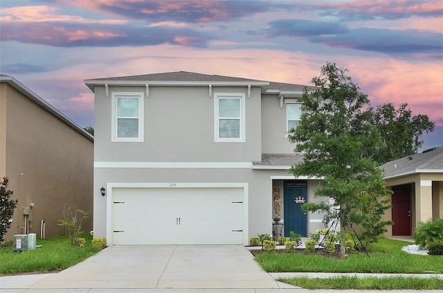 traditional home with stucco siding, concrete driveway, a garage, and a shingled roof