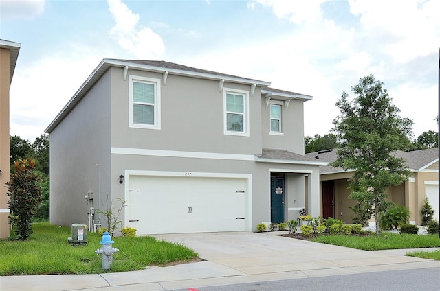 traditional-style home with an attached garage, a shingled roof, central AC unit, stucco siding, and driveway