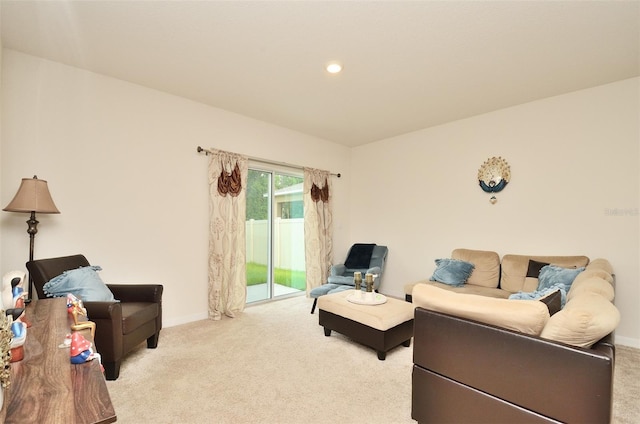 living area with recessed lighting, light colored carpet, and baseboards