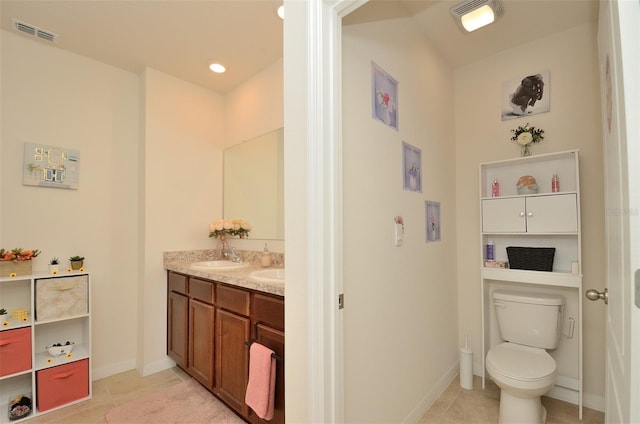 bathroom with tile patterned floors, visible vents, toilet, and double vanity