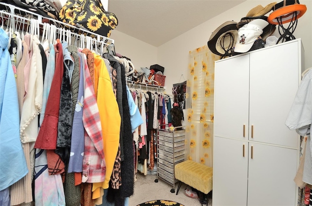 walk in closet featuring carpet flooring