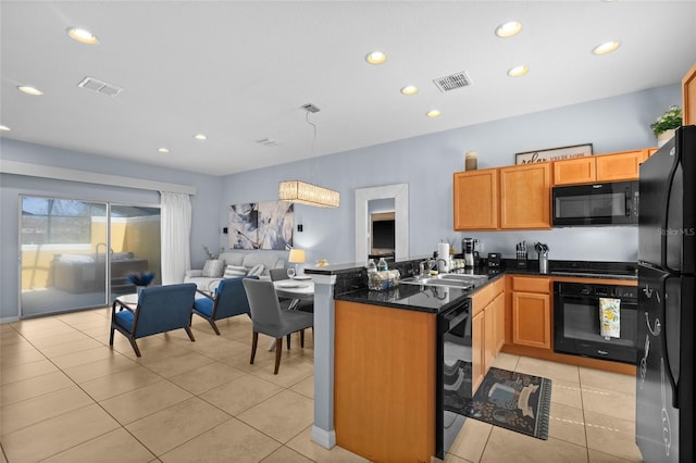 kitchen with black appliances, open floor plan, light tile patterned floors, and visible vents