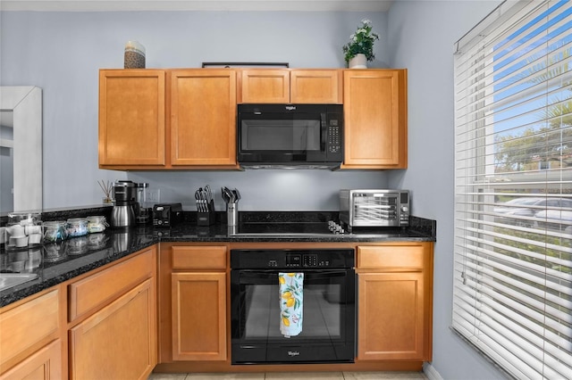 kitchen with black appliances and dark stone counters