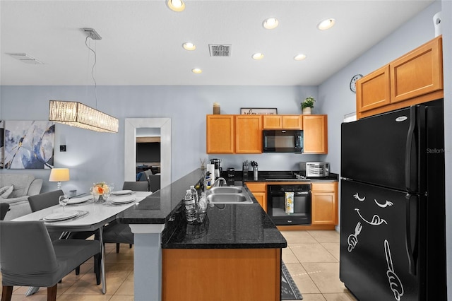 kitchen featuring black appliances, light tile patterned flooring, visible vents, and a sink