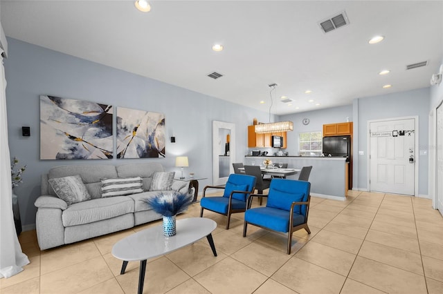 living room with light tile patterned floors, recessed lighting, and visible vents