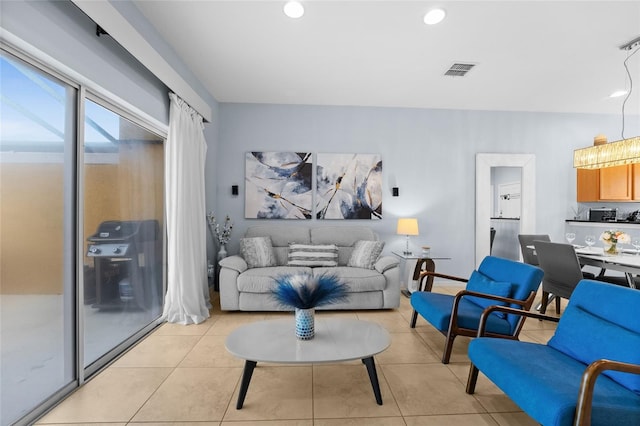 living area with light tile patterned floors, recessed lighting, and visible vents