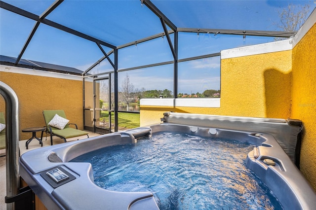 view of pool featuring a lanai and a hot tub