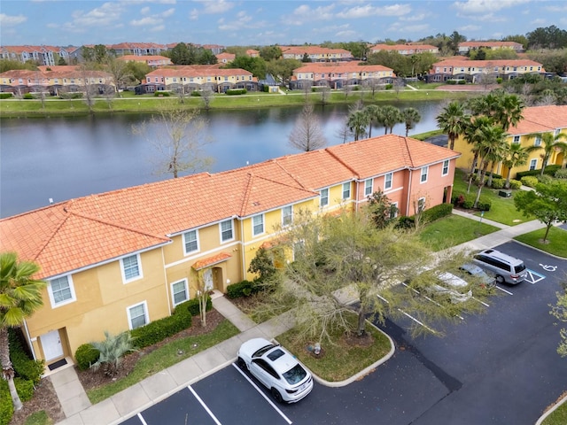 drone / aerial view featuring a residential view and a water view