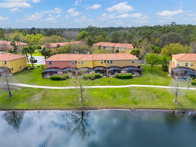 birds eye view of property with a forest view and a water view