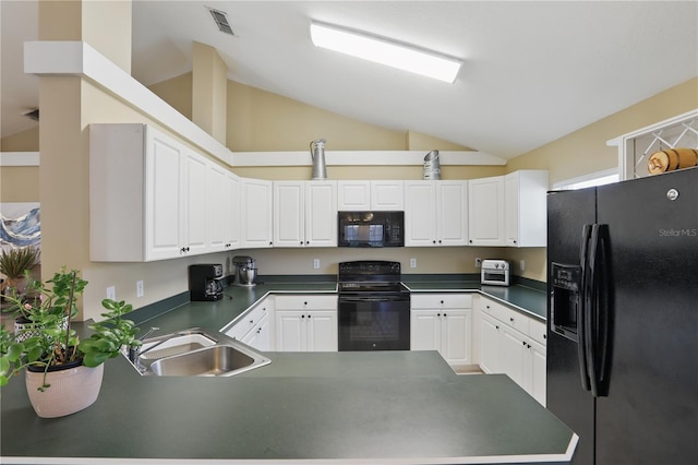 kitchen featuring a sink, dark countertops, black appliances, and a peninsula