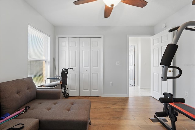 interior space with wood finished floors, baseboards, and ceiling fan