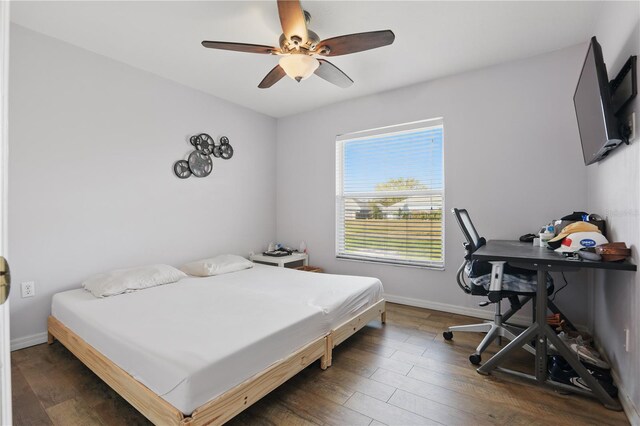 bedroom with baseboards, wood finished floors, and a ceiling fan