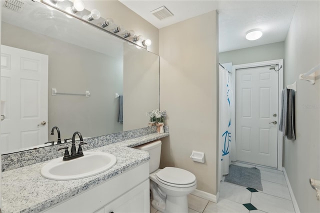 full bath featuring vanity, toilet, baseboards, and visible vents