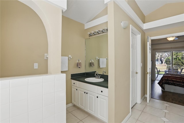 bathroom featuring vanity, ceiling fan, tile patterned flooring, and vaulted ceiling