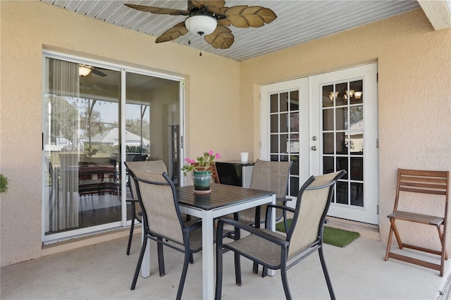 view of patio with outdoor dining space, a ceiling fan, and french doors