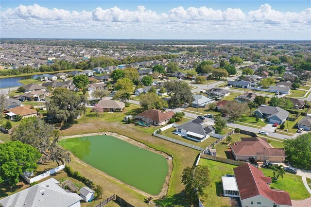 birds eye view of property featuring a residential view and a water view