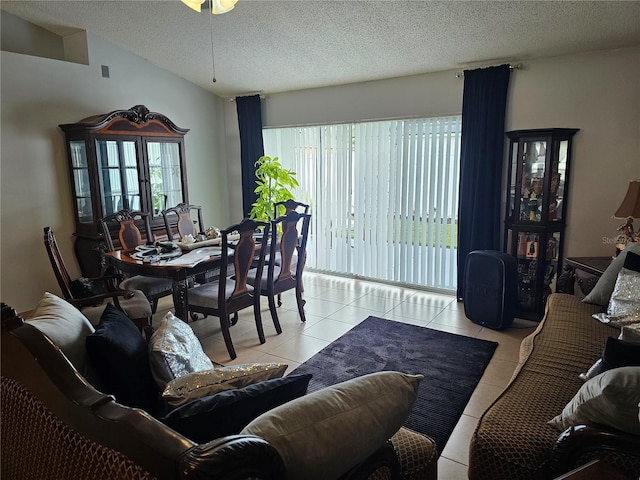 633 Kangaroo Dr, Kissimmee, FL 34759 - living room with light tile patterned flooring, lofted ceiling, and a textured ceiling