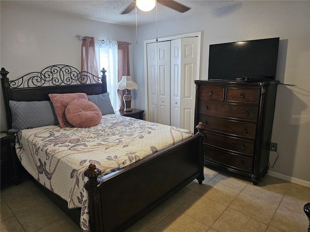 633 Kangaroo Dr, Kissimmee, FL 34759 - bedroom featuring baseboards, a textured ceiling, light tile patterned flooring, ceiling fan, and a closet
