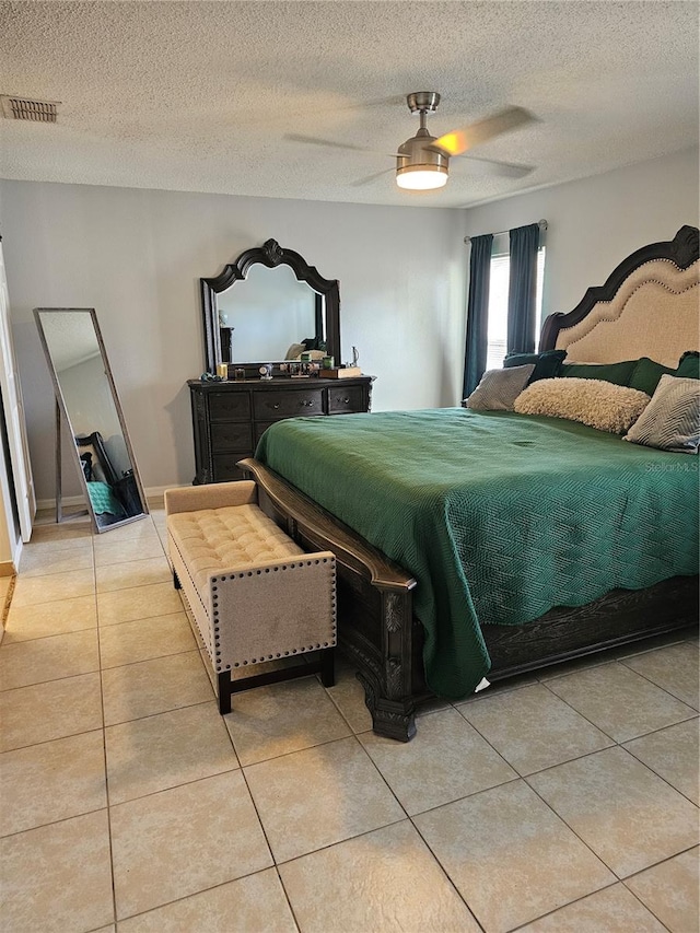 633 Kangaroo Dr, Kissimmee, FL 34759 - bedroom featuring a ceiling fan, light tile patterned flooring, a textured ceiling, and visible vents