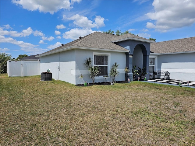 633 Kangaroo Dr, Kissimmee, FL 34759 - single story home with a gate, fence, a front lawn, stucco siding, and cooling unit