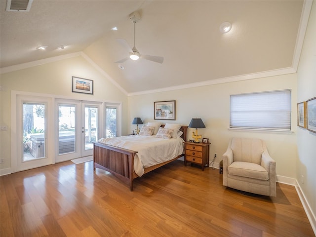 bedroom with wood finished floors, visible vents, access to exterior, vaulted ceiling, and french doors