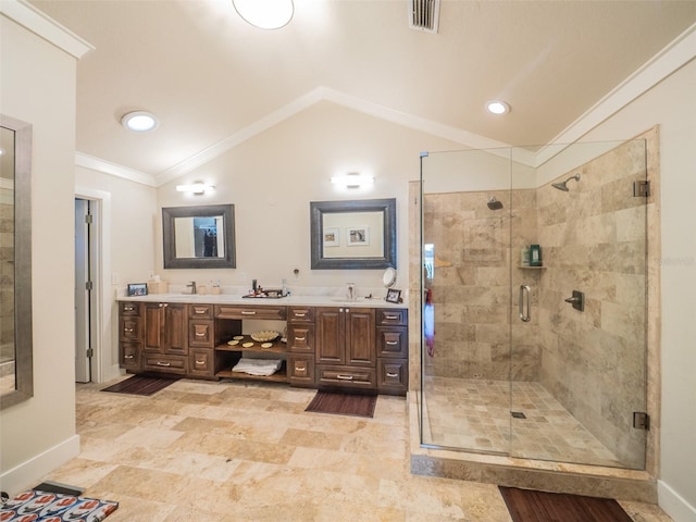 bathroom with visible vents, crown molding, vaulted ceiling, a stall shower, and a sink